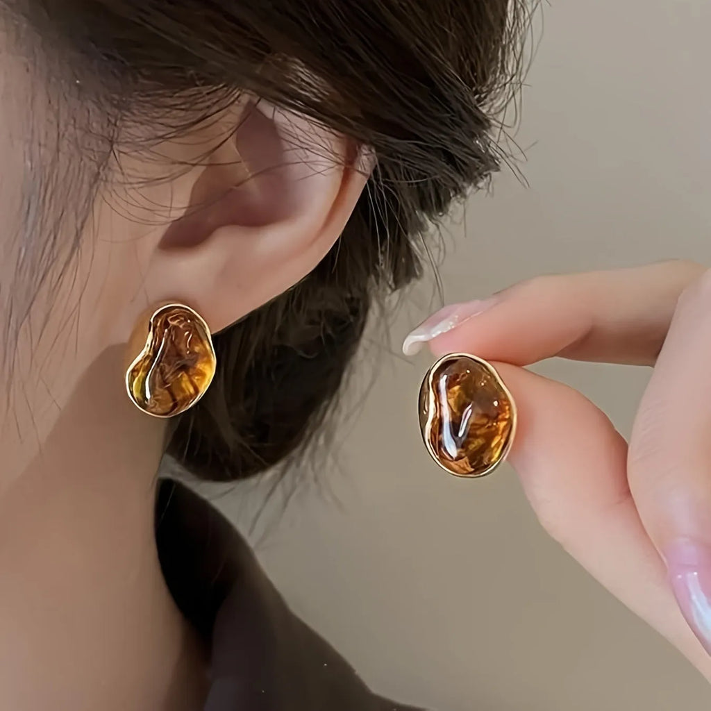 Three pairs of handmade geometric holiday earrings with tassel details in electroplated alloy