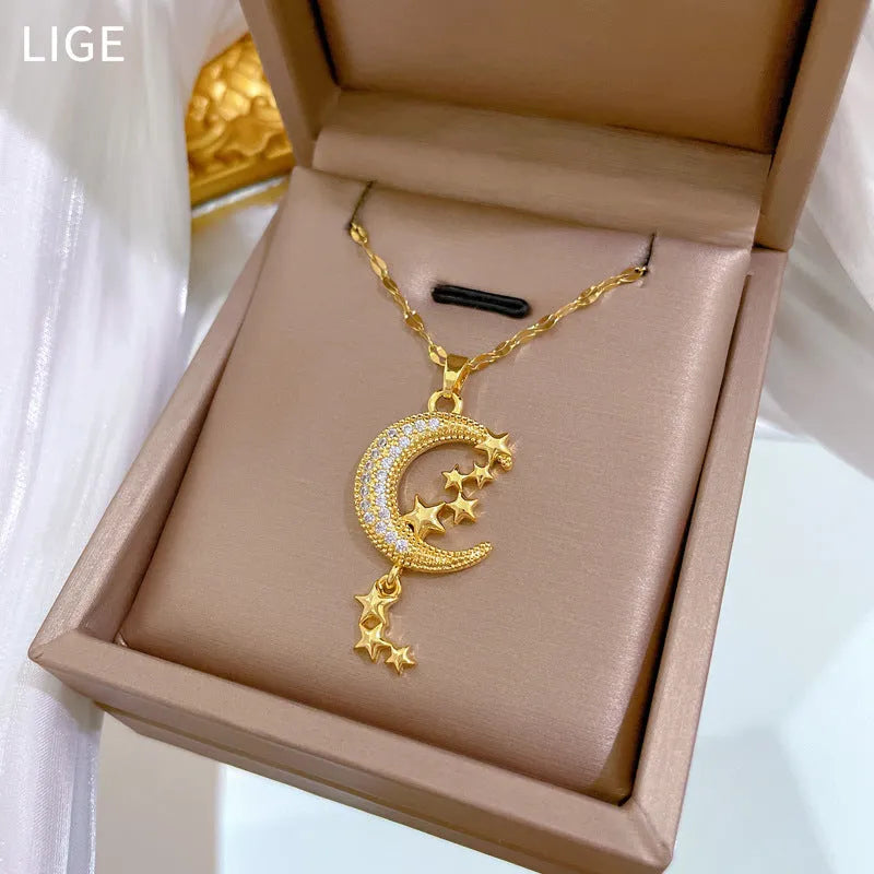 Moon pendant necklace with tassel design and diamond accents on stainless steel chain