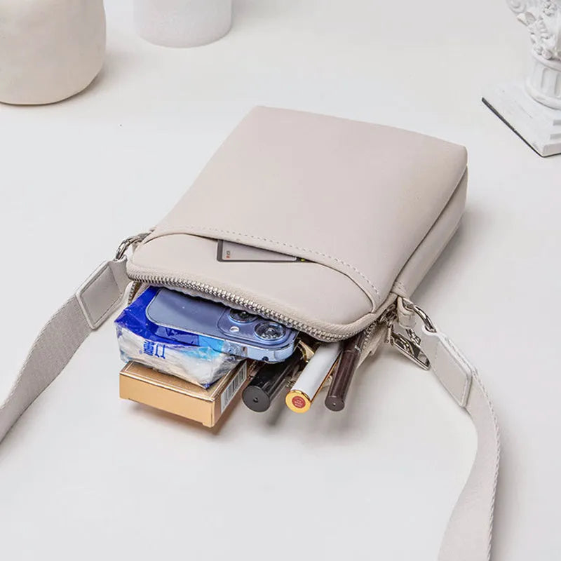 Simple solid colour PU leather crossbody phone bag for women shown in beige.