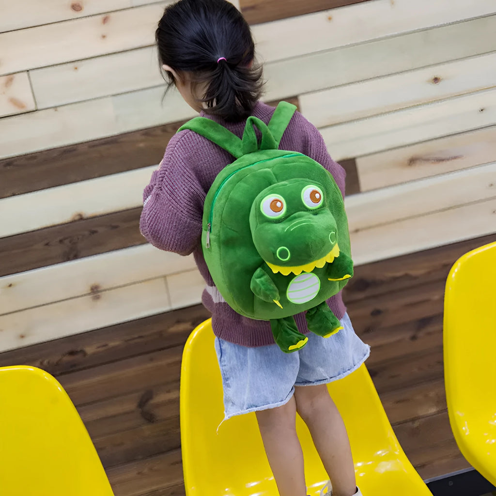 Soft plush blue dinosaur character backpack with embroidered details and a soft handle.