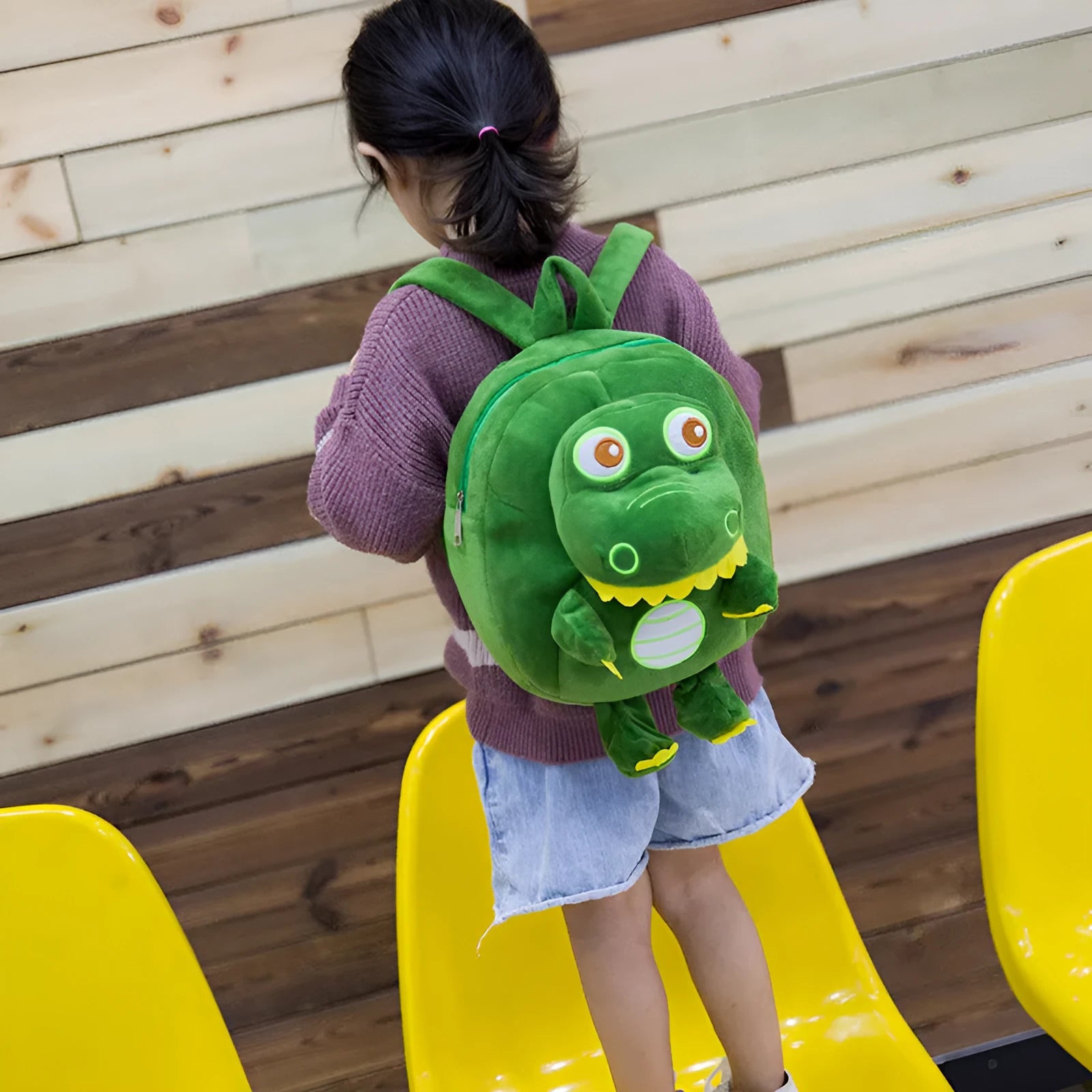 Soft plush blue dinosaur character backpack with embroidered details and a soft handle.