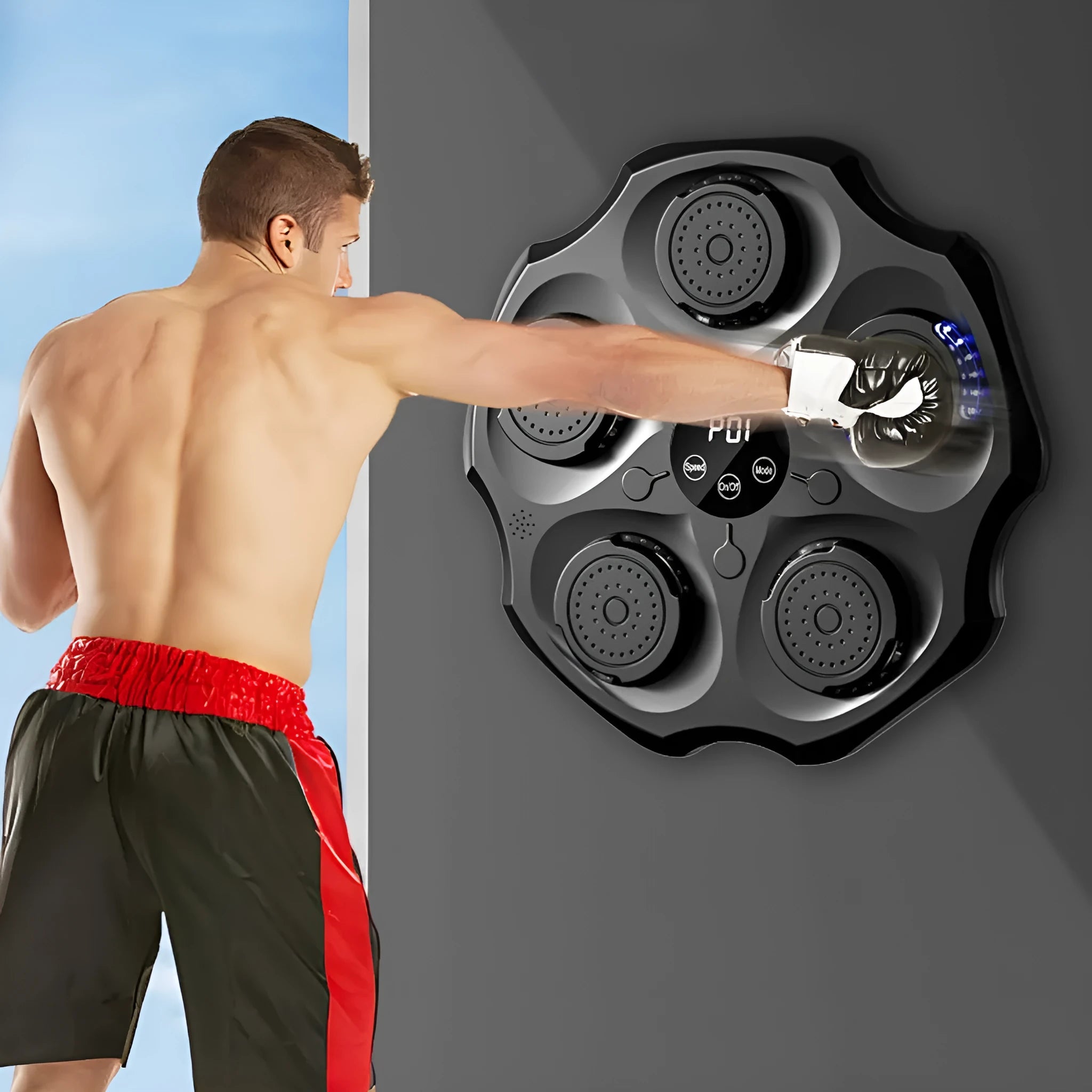 Black hanging-style boxing wall target with Bluetooth music control for home fitness.
