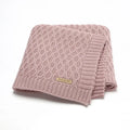 Solid colour infant hug blanket with textured three-dimensional lines, shown in a light colour option.