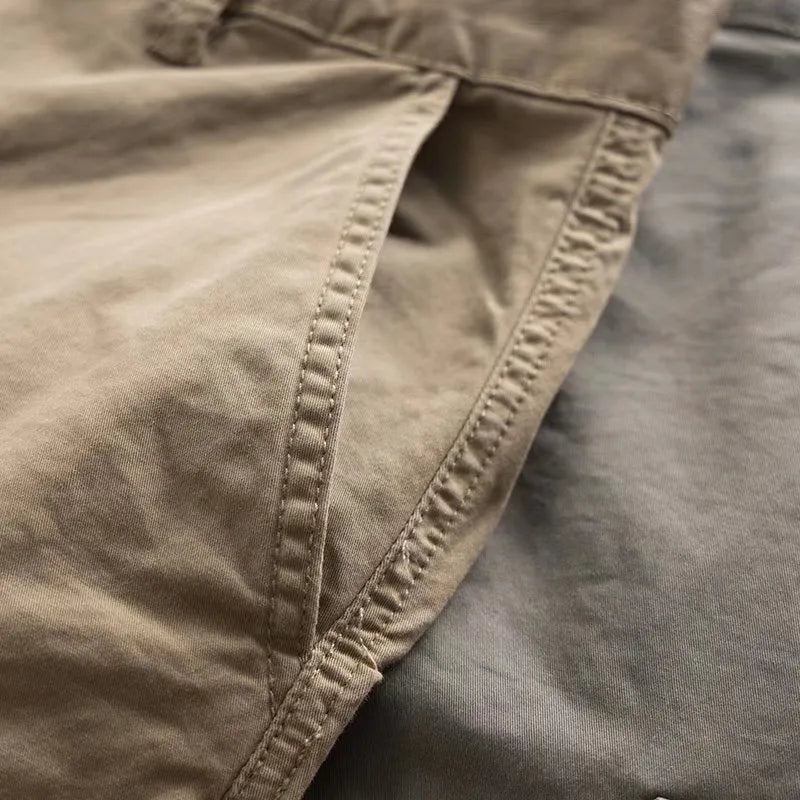 Men's multi-pocket cotton work trousers in cropped length showing cargo pocket design