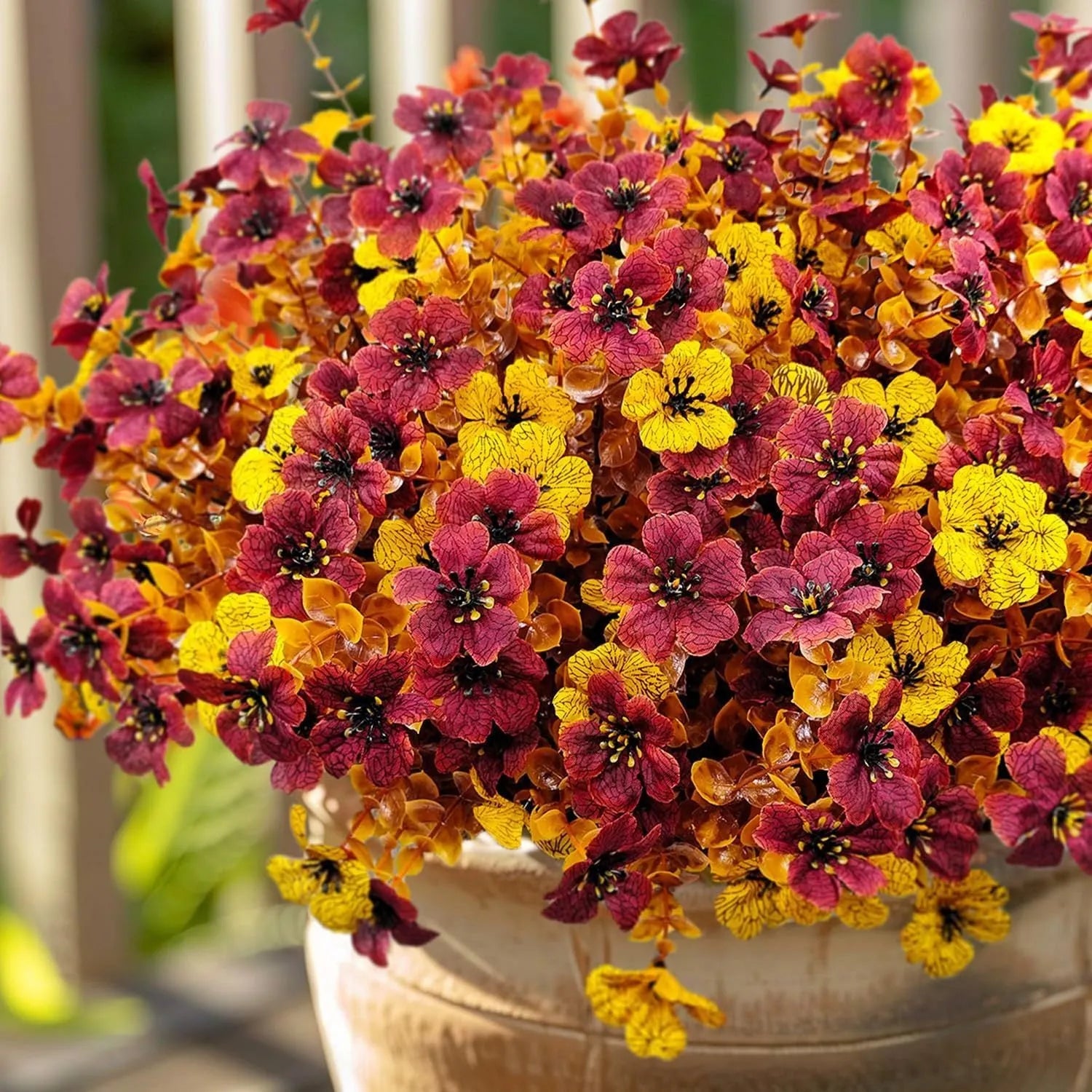 Artificial flower bouquet in autumn colours including orange, yellow, and red tones