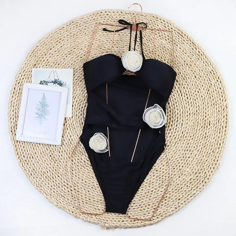 Women's nylon one-piece swimsuit with 3D flower detail in black or blue stripes colours