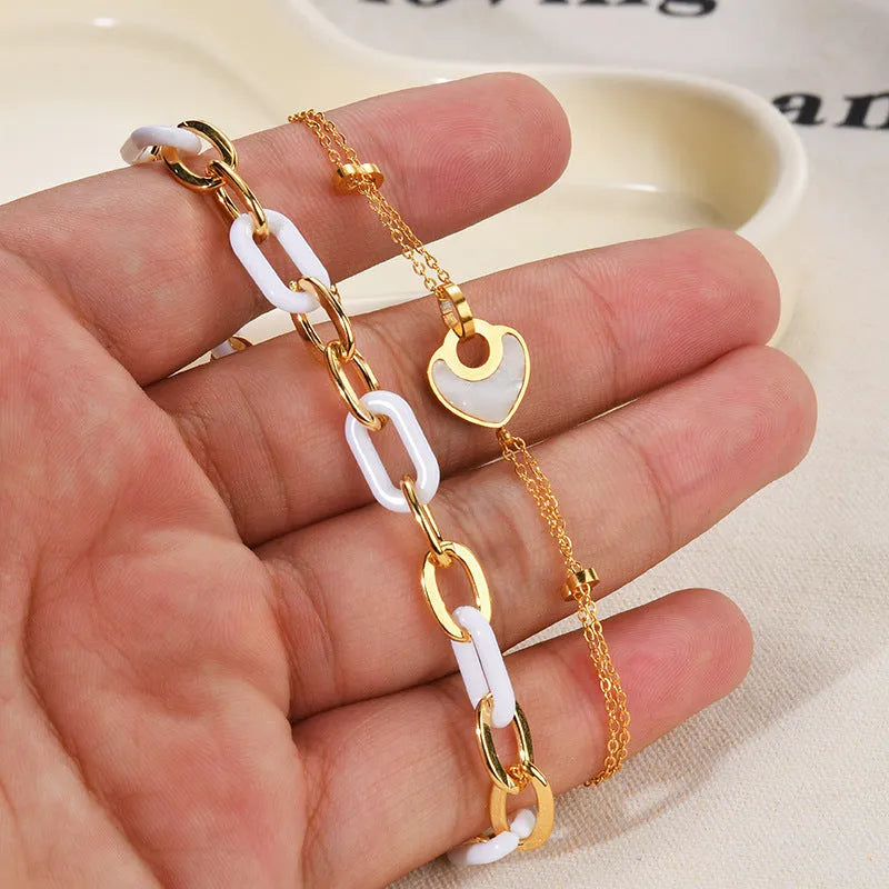 Stainless steel and resin heart-shaped bracelet for women with double layer design.