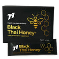 Jar of dark black T1 Thai forest honey with thick texture on a wooden surface