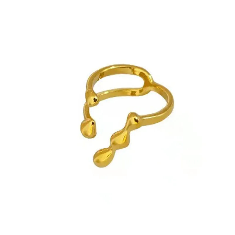 Brass opening ring with spherical details in gold or silver colour on display surface
