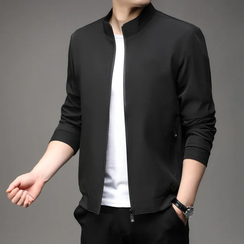 Man wearing a loose-fit Korean-style casual jacket in a dark colour, showing the lapel design, zip, and pockets.