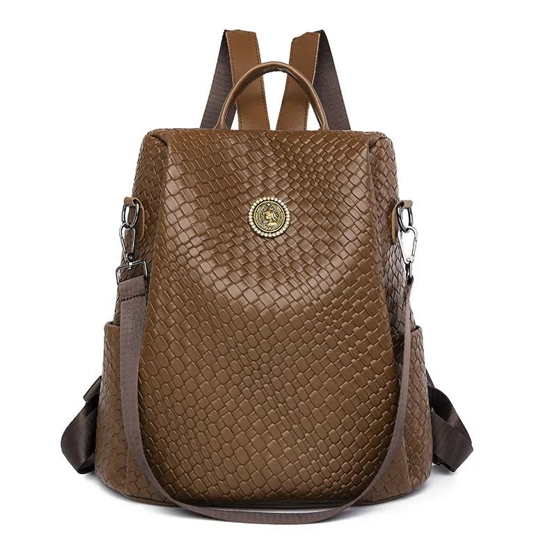 Women's anti-theft backpack with waterproof PU construction showing organisational compartments and urban simplicity styling