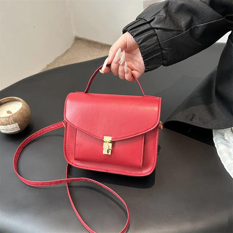 Retro style square messenger bag in PU with a crossbody strap and internal document pocket.