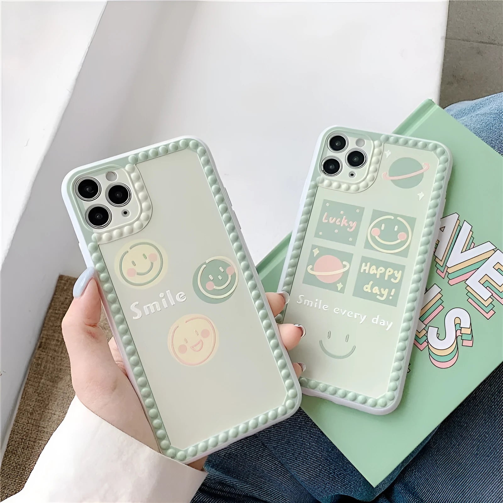 Green geometric pattern iPhone case with smiley faces and polka dot frames on a phone