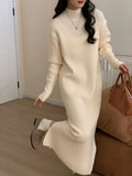 Half turtleneck knitted dress in a solid colour on a model, showing high waist and midi length.