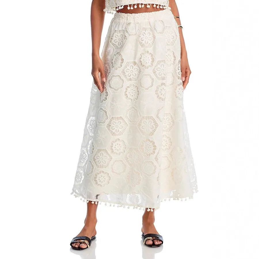 White women's retro suit with embroidery details showing sleeveless top and long skirt