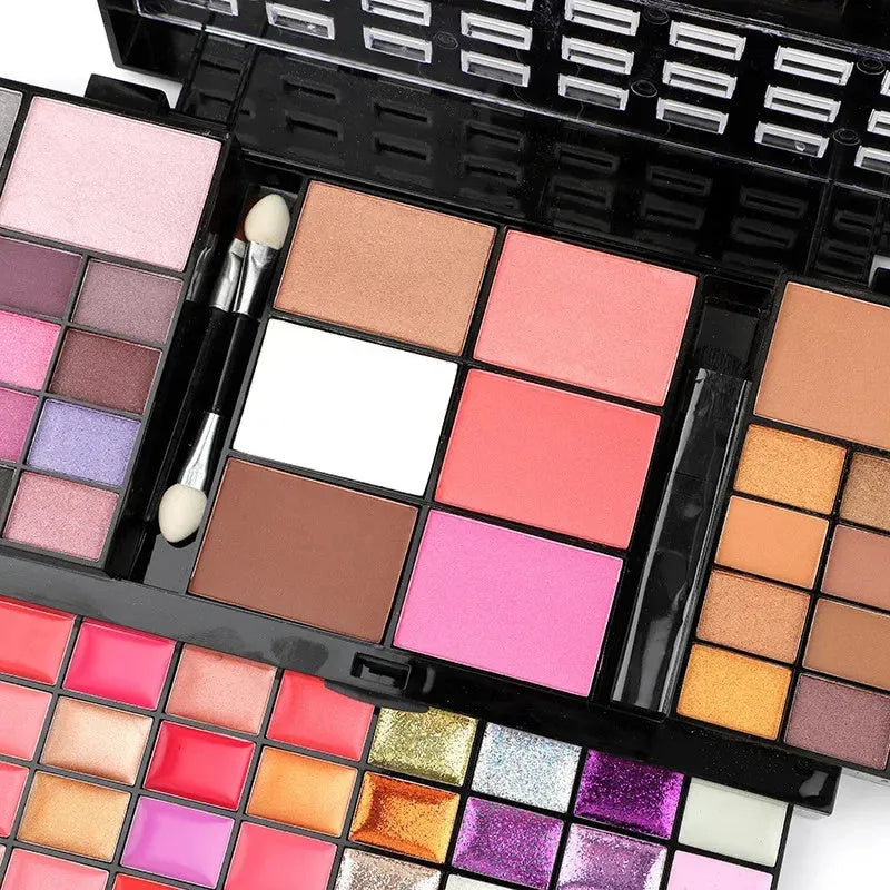 74 colour makeup combination palette open showing four layers of eyeshadows, lip glosses, and face powders with applicators