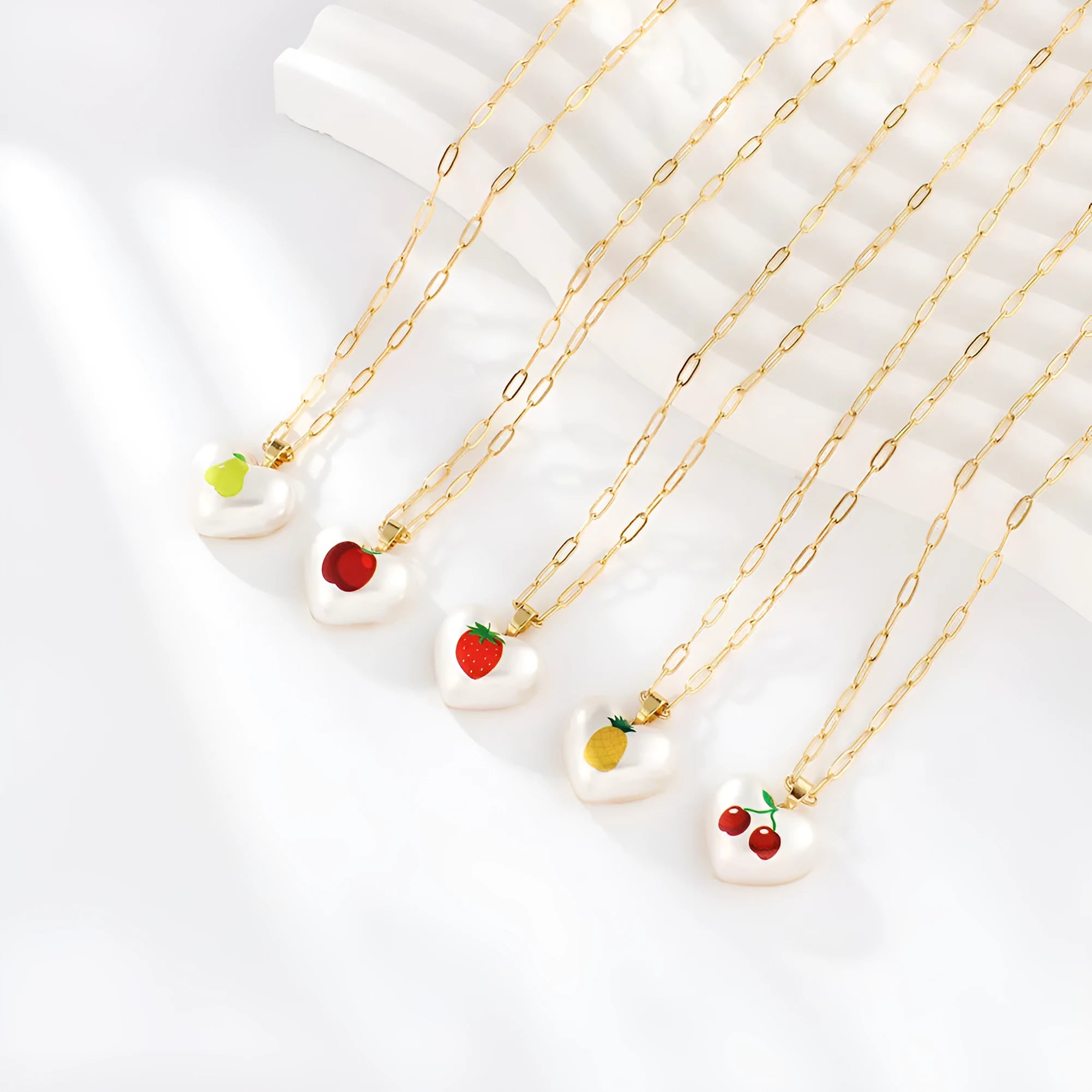 Adjustable heart-shaped necklace with fruit pendant charm showing five colour options