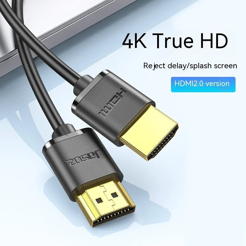 Thin flexible HDMI cable with gold-plated connectors on a white background.