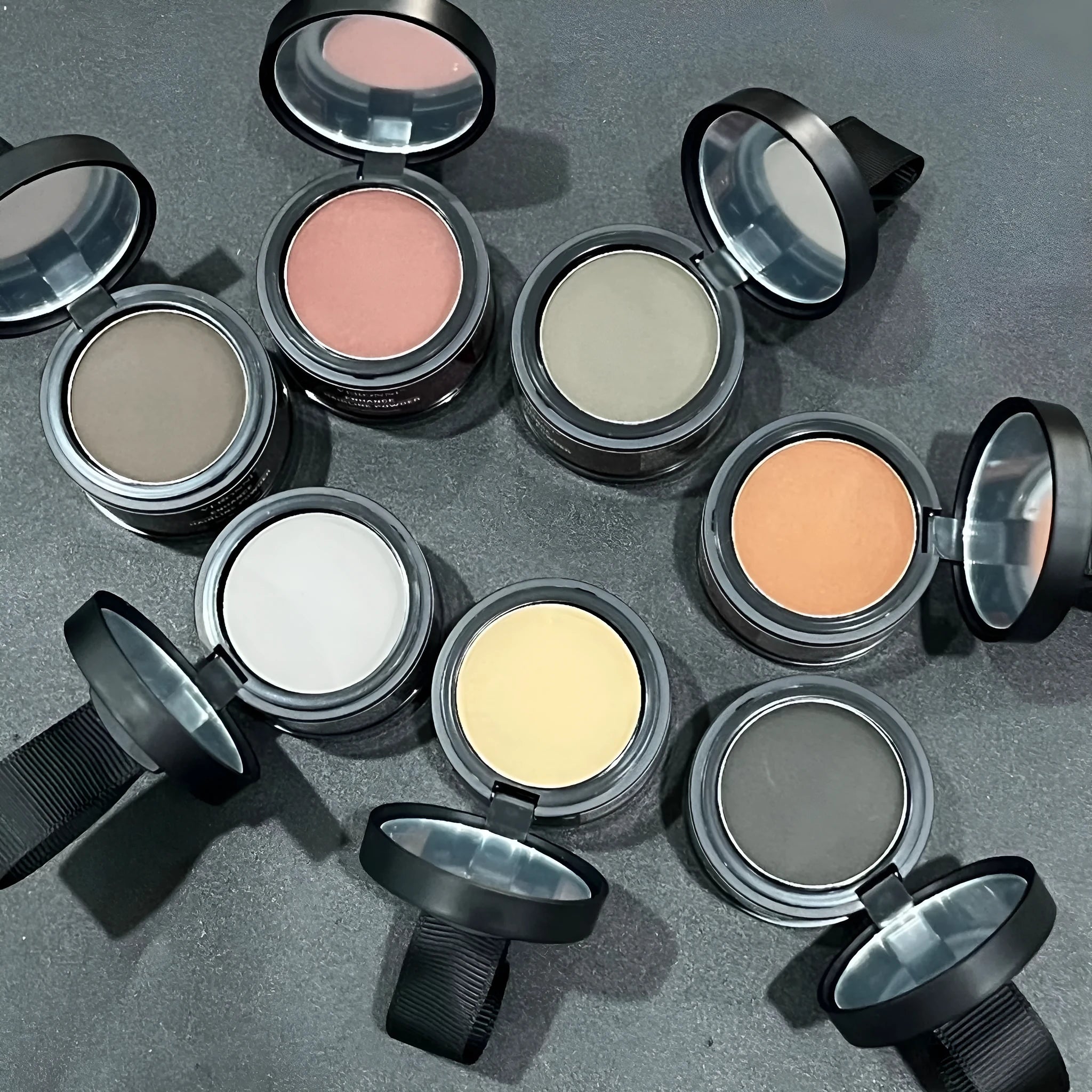 Hairline powder container showing 14 colour shades for shadow repair and skin tone improvement