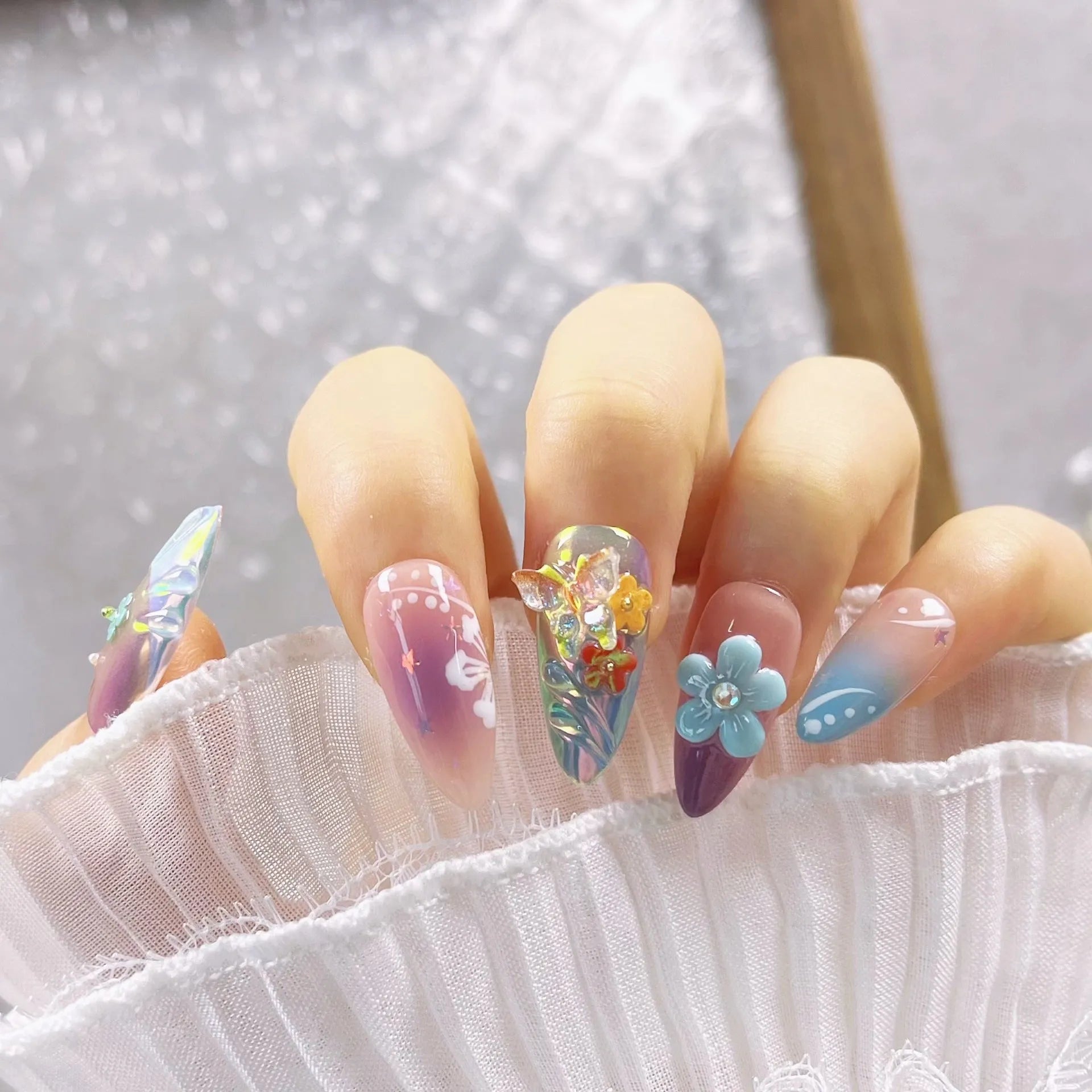 Handmade embossed nail art stickers showing floral and butterfly patterns in almond shape