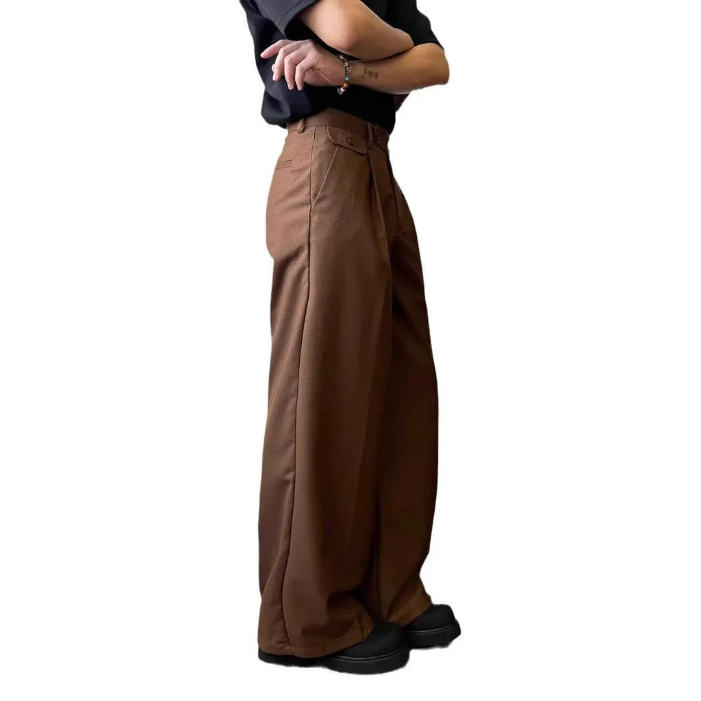 Men's straight-leg wide trousers in black, showing casual suit pant style with draping fabric.