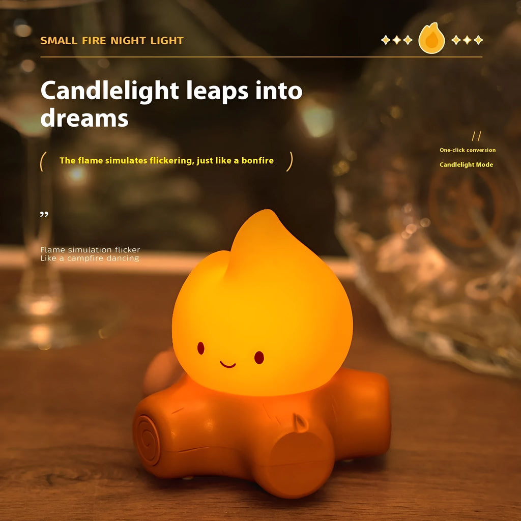 Cartoon silicone small fire pile night lamp with yellow light on a surface.