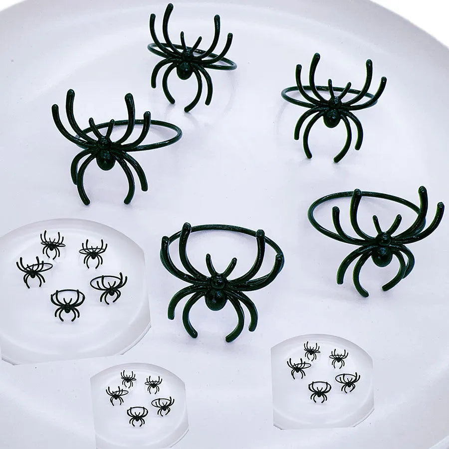 Six black spider-themed alloy napkin rings for Halloween table decorations