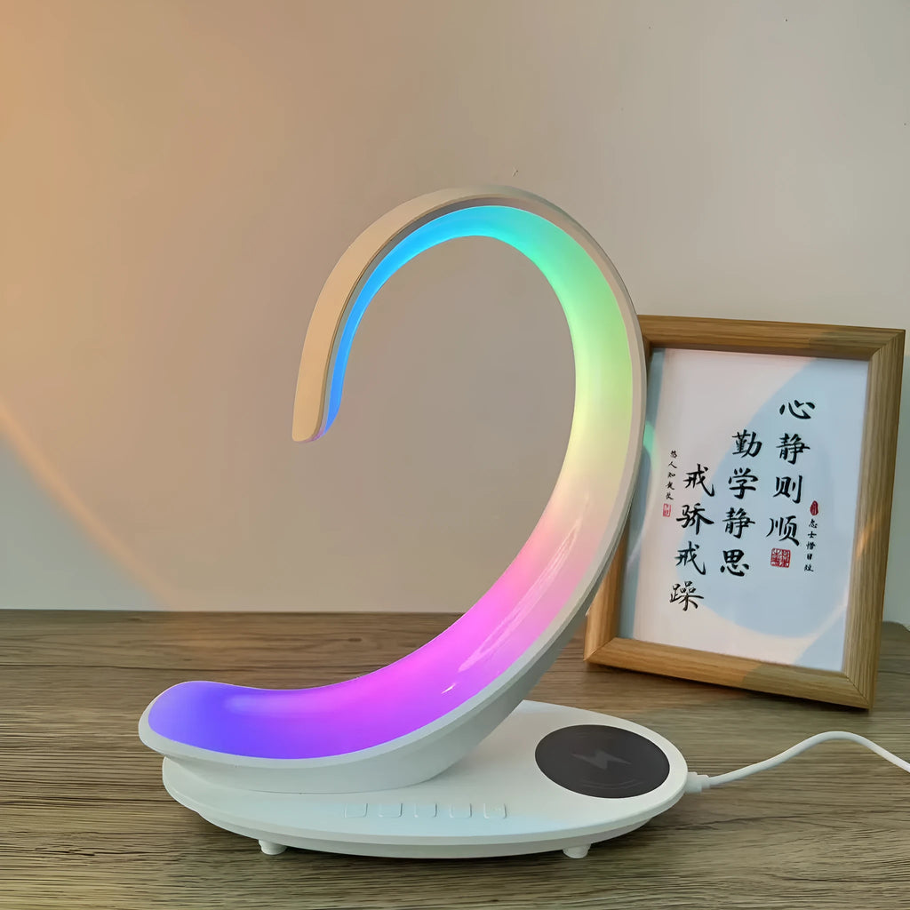 White swan shaped desktop lamp with wireless charging pad, Bluetooth speaker, and colourful LED lighting