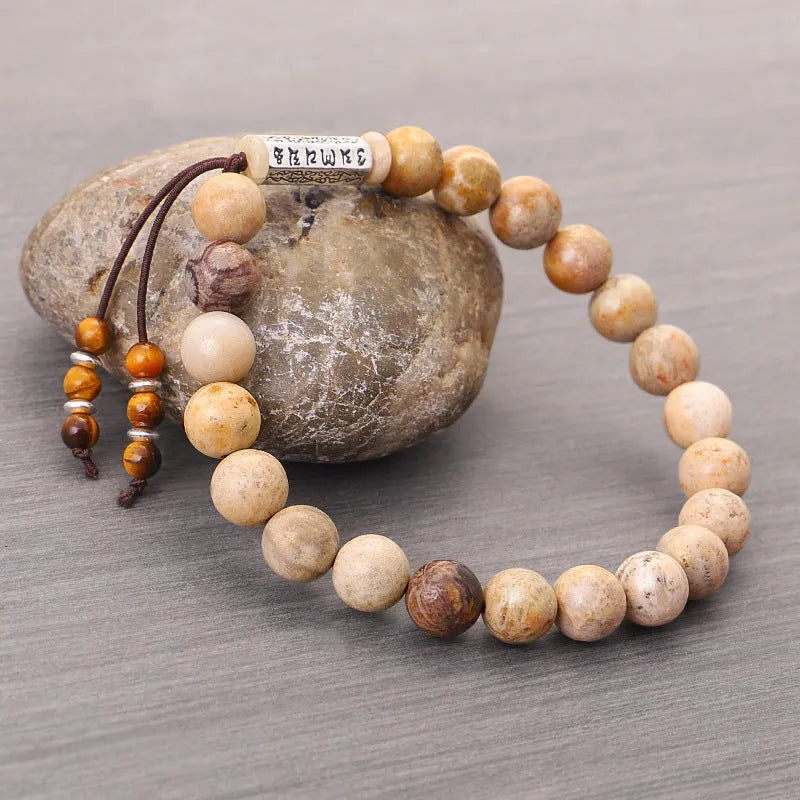 Original design handmade stone bead bracelet in natural wood colour on wrist.
