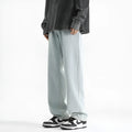 Men's light blue washed straight leg jeans with button waist, made from cotton.