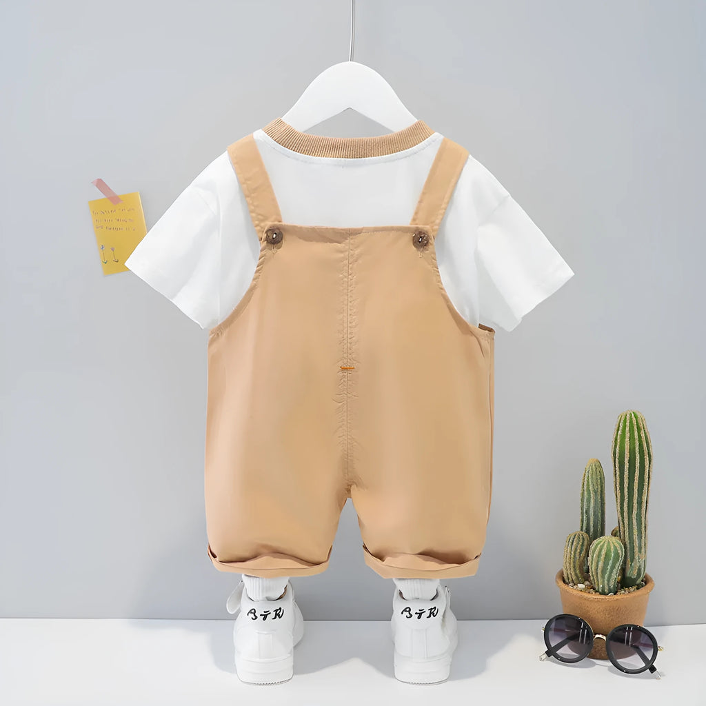 Baby wearing yellow cotton cartoon overalls with short sleeves and adjustable straps