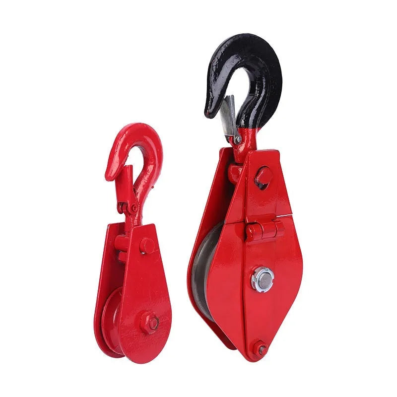 Red steel industrial lifting pulley with a safety latch and large hook opening.