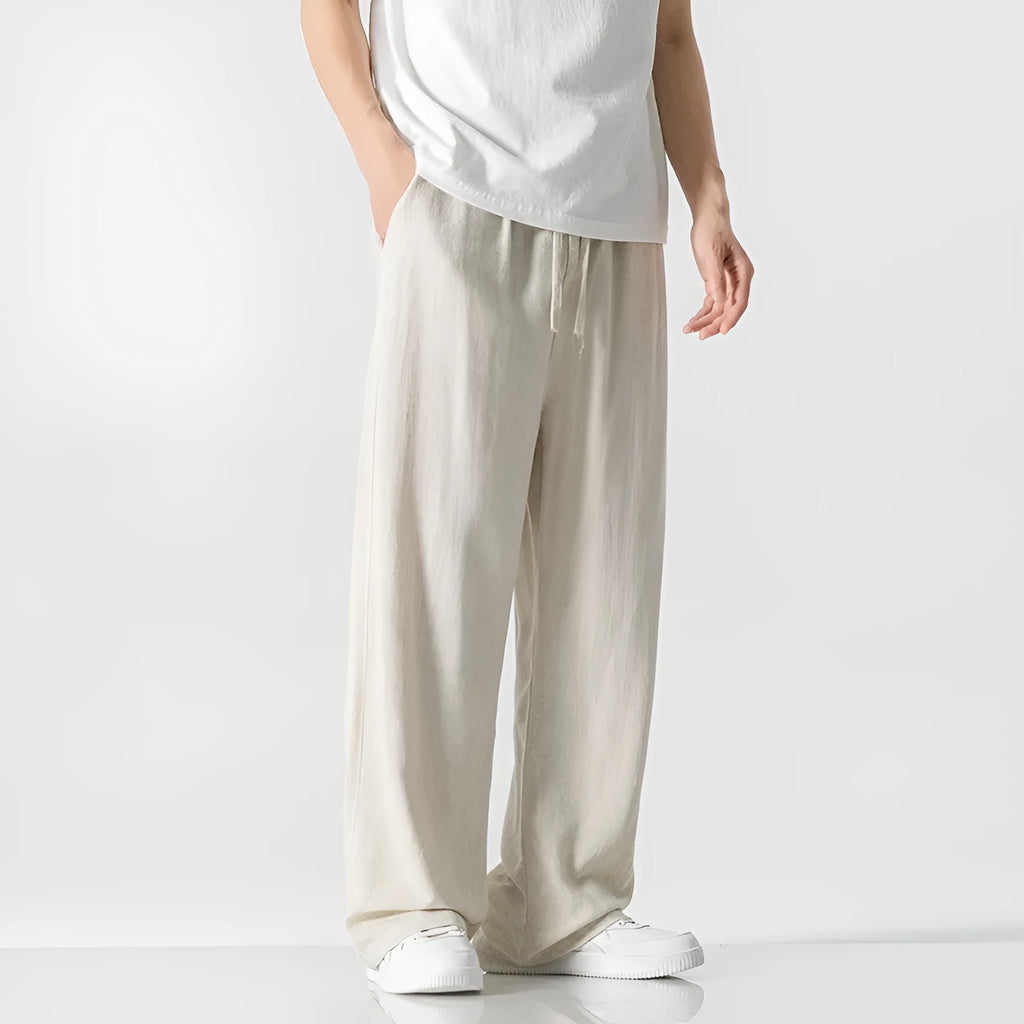 Men's beige bamboo fibre linen trousers with a straight leg, cropped length, and drawstring waist on a mid-rise.