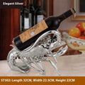 Lobster-shaped wine rack ornament in metallic finish displaying wine bottle