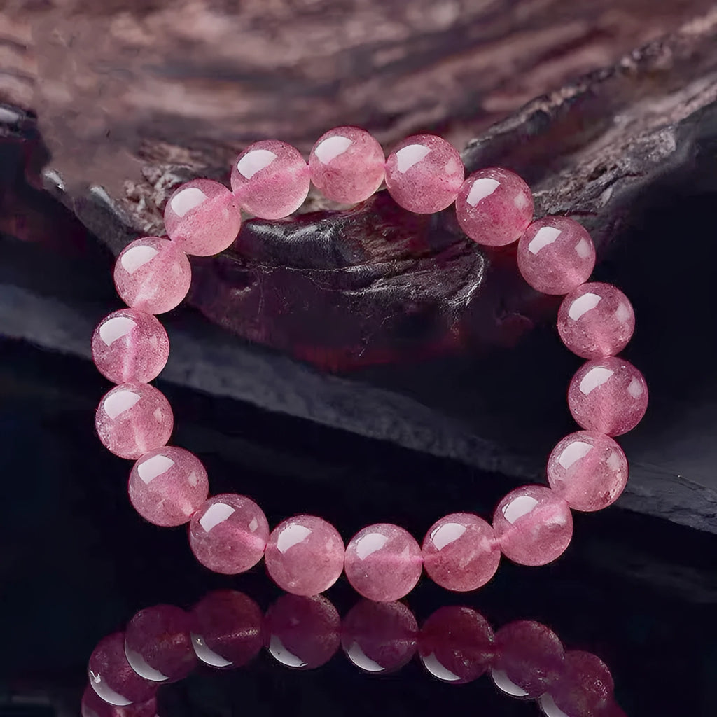 Women's adjustable bracelet made from polished strawberry quartz beads in 6mm, 8mm, or 10mm sizes.