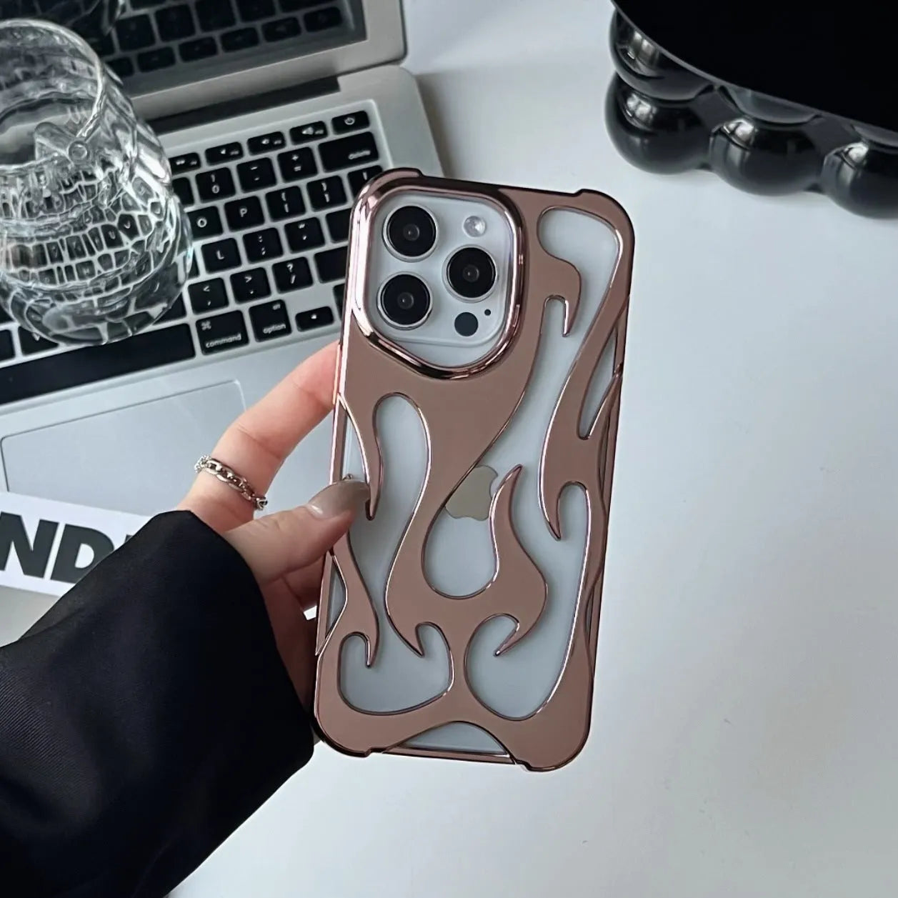 Electroplated hollow flame pattern design on a soft TPU iPhone case, shown in a silver finish.