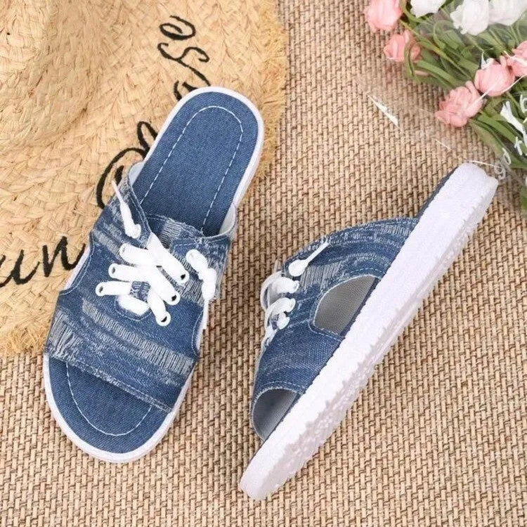 Blue Roman style women's flat canvas slippers with cloth lining, shown from the side.