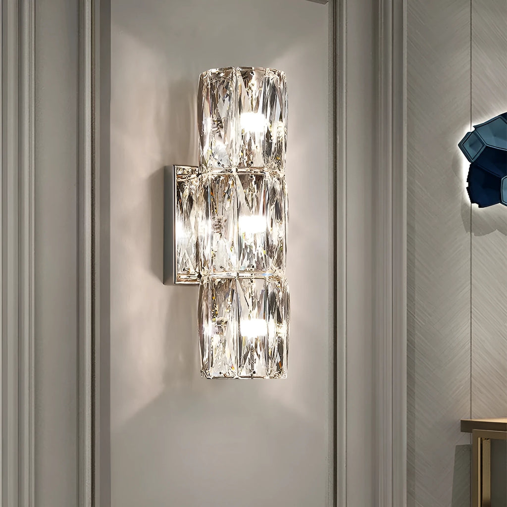 Modern crystal shade wall lamp in gold or chrome stainless steel, mounted on a wall.