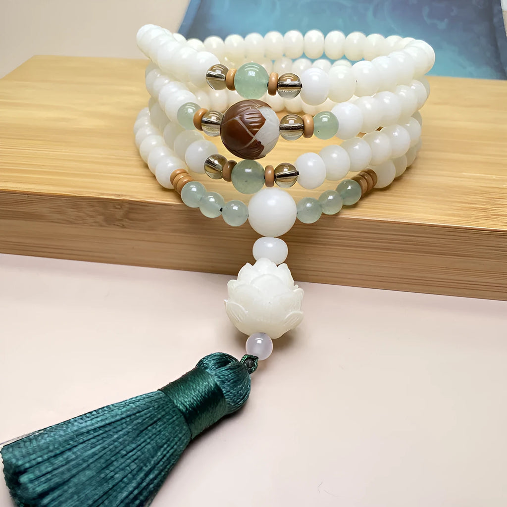 White Jade Bodhi stone beaded bracelet with 108 beads on a wrist.
