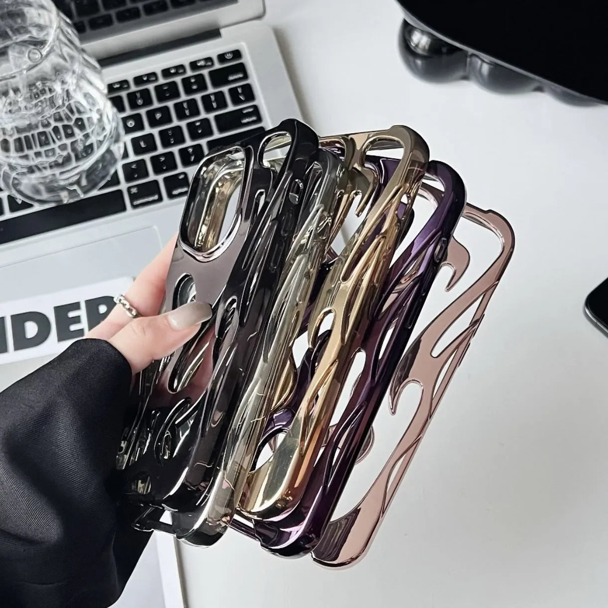 Electroplated hollow flame pattern design on a soft TPU iPhone case, shown in a silver finish.