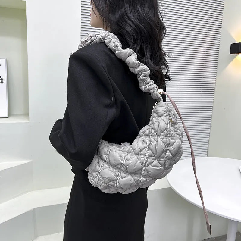 Women's lightweight nylon underarm messenger bag in a solid colour with an adjustable long shoulder strap.