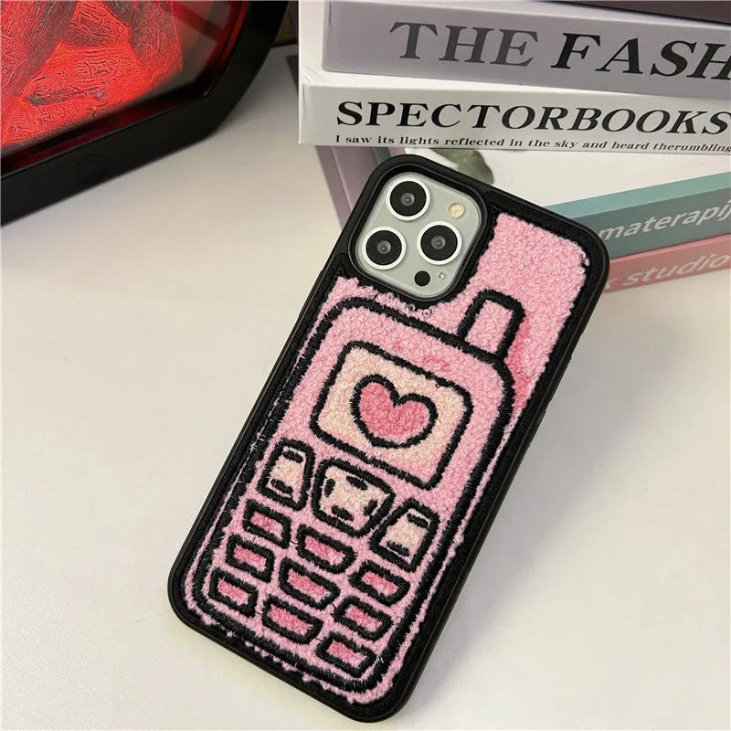 Pink iPhone back cover with a raised embroidered towel pattern design.