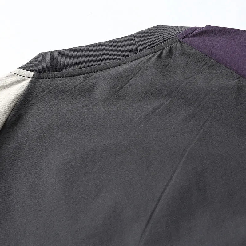 Dark grey loose fit T-shirt with contrasting colour raglan short sleeves on a hanger