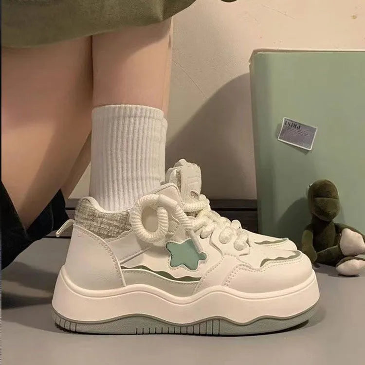 Women's green platform sneakers with patent leather finish, round toe, and lace-up front