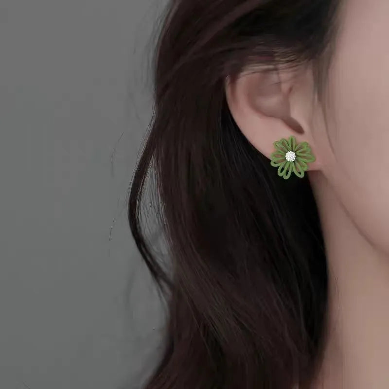 Alloy flower-shaped stud earrings in white and green, yellow and white, and blue orange colour combinations with butterfly clutch fastenings