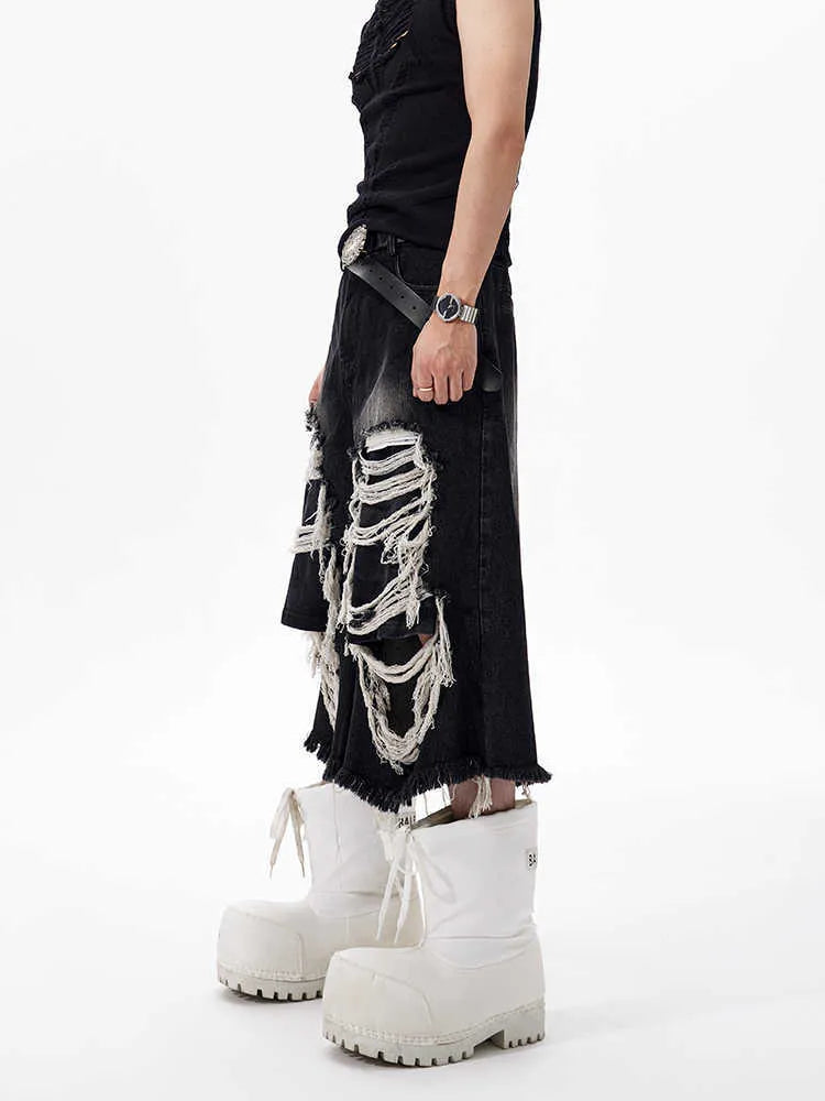 Black wide leg cropped jeans with mid-high waist and ripped patch detail on the legs.
