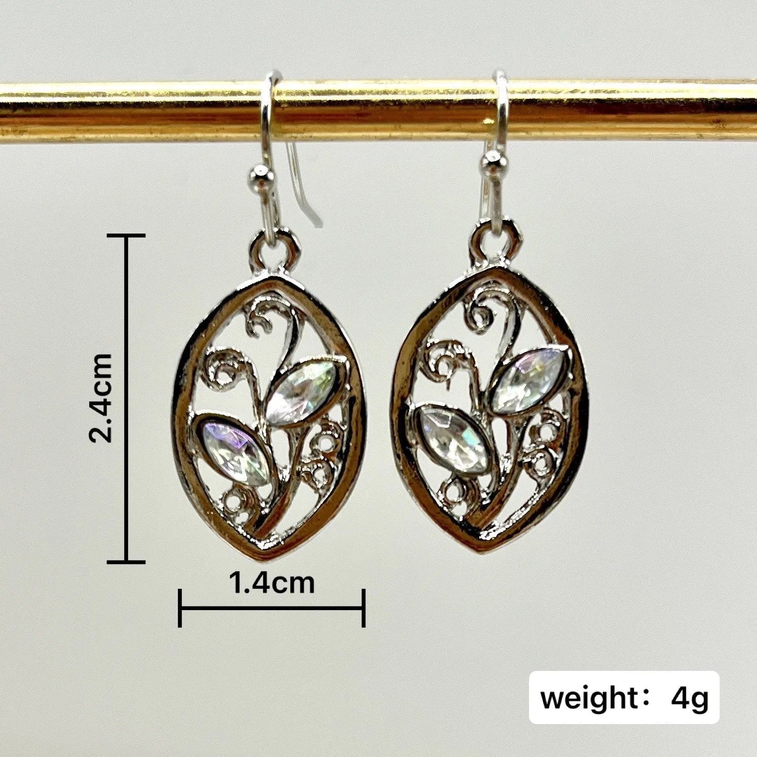 Silver alloy earrings with leaf shape containing colourful embedded moonstone