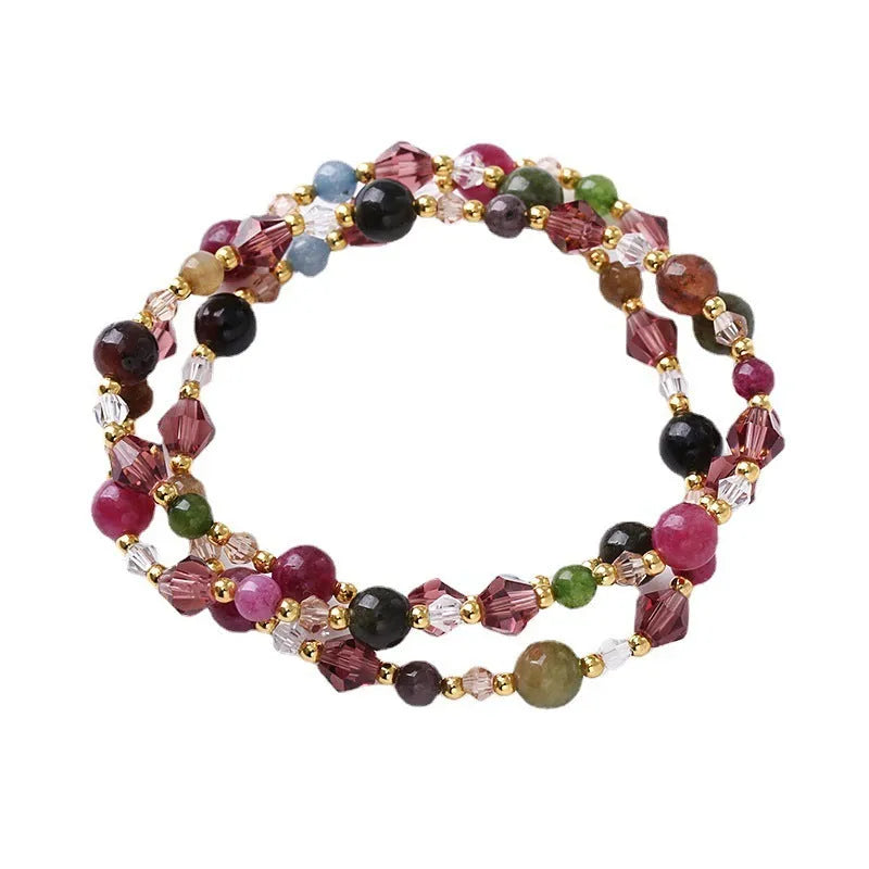 Women's adjustable three-ring bracelet with tourmaline, strawberry quartz, and amethyst crystal beads on elastic cord.