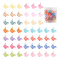 Assortment of glittery mini butterfly-shaped hair claw clips in multiple colours on a white background.