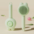 Self-cleaning pet grooming brush with coloured handle and stainless steel comb teeth